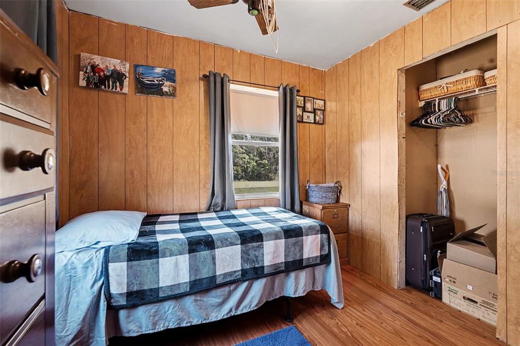 2102 Columbus Drive Brandon, FL 33510 - Photo 24 of 28 a bedroom with a bed a dresser and wooden floor