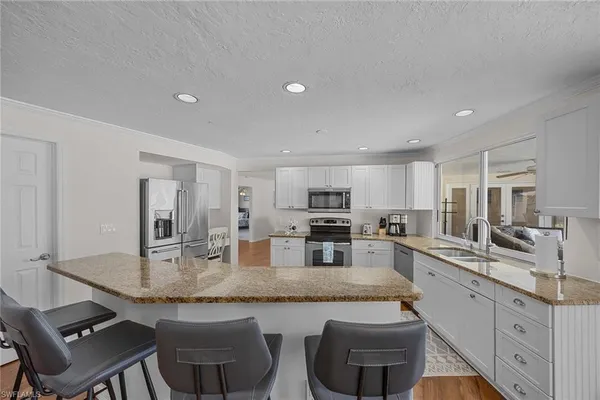 a kitchen with stainless steel appliances granite countertop a sink and cabinets