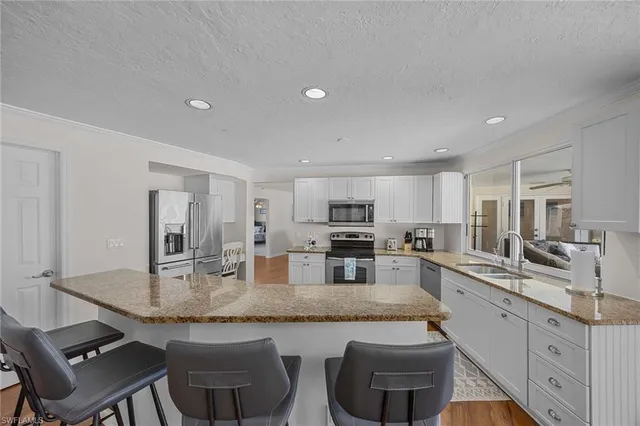 a kitchen with stainless steel appliances granite countertop a sink and cabinets