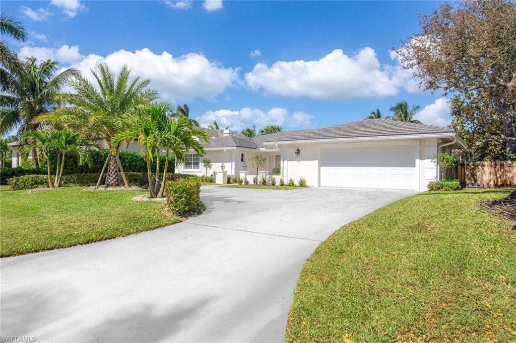 707 Portside Drive Naples, FL 34103 - Photo 2 of 35 a view of a house with palm trees