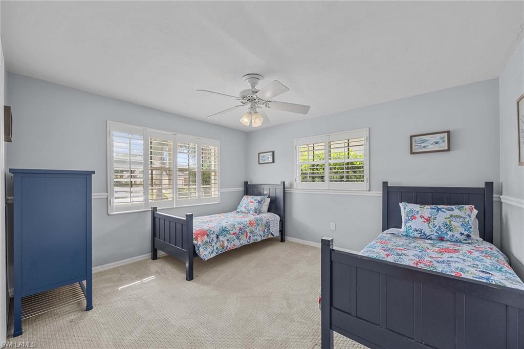 707 Portside Drive Naples, FL 34103 - Photo 22 of 35 a bedroom with a bed and window