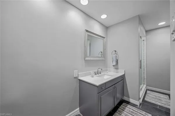 a bathroom with a sink a mirror and vanity