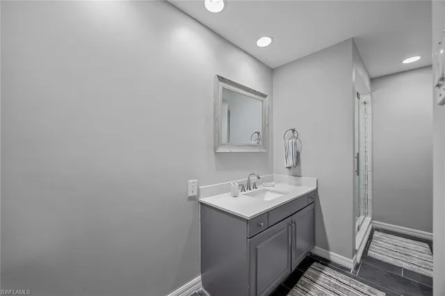 a bathroom with a sink a mirror and vanity