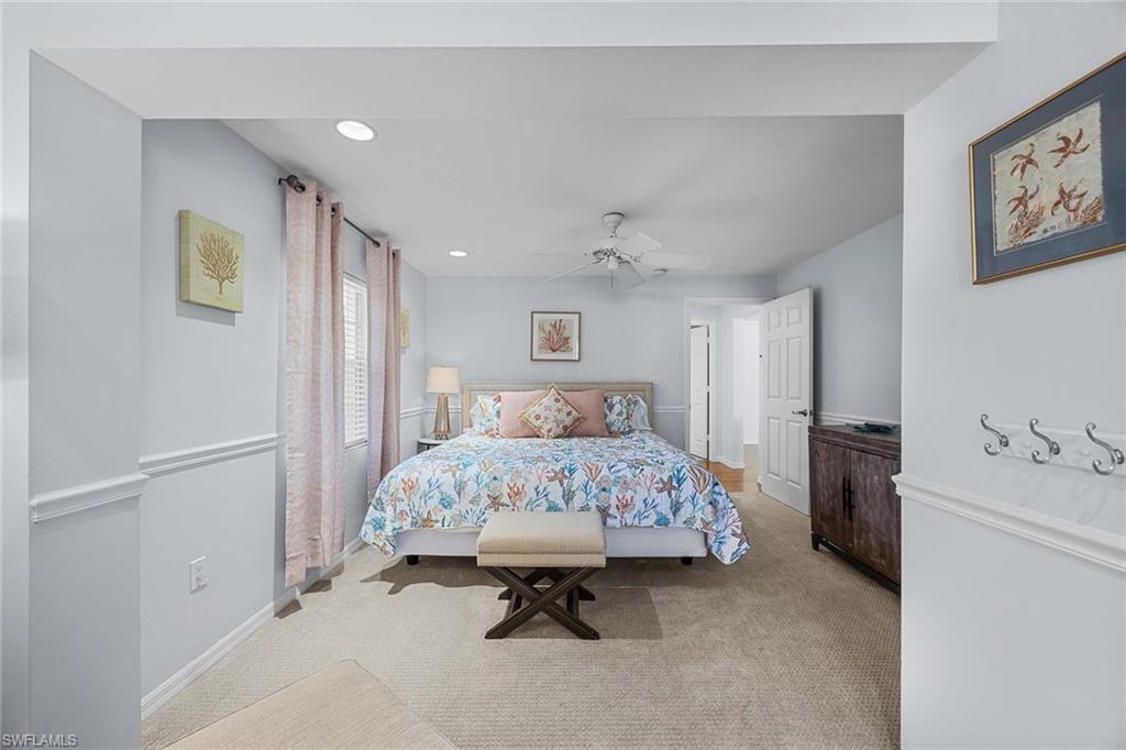 707 Portside Drive Naples, FL 34103 - Photo 26 of 35 a spacious bedroom with a bed and a table in it