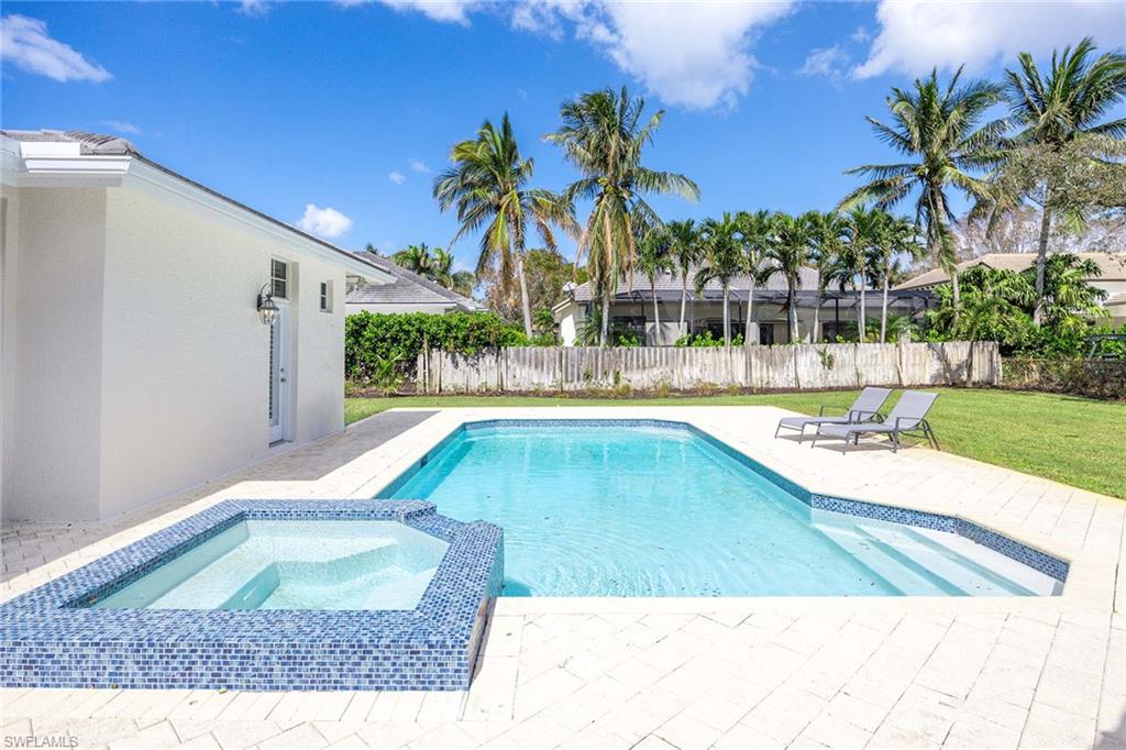 707 Portside Drive Naples, FL 34103 - Photo 30 of 35 a view of a swimming pool with a lounge chairs