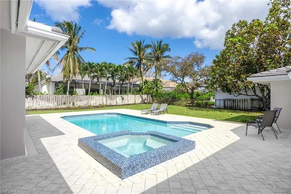 a view of a swimming pool with a lounge chairs