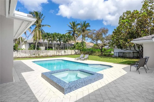 a view of a swimming pool with a lounge chairs