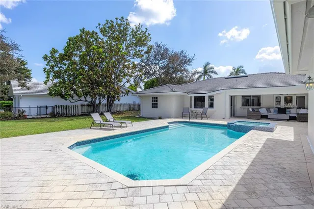 a view of a house with a swimming pool and a yard