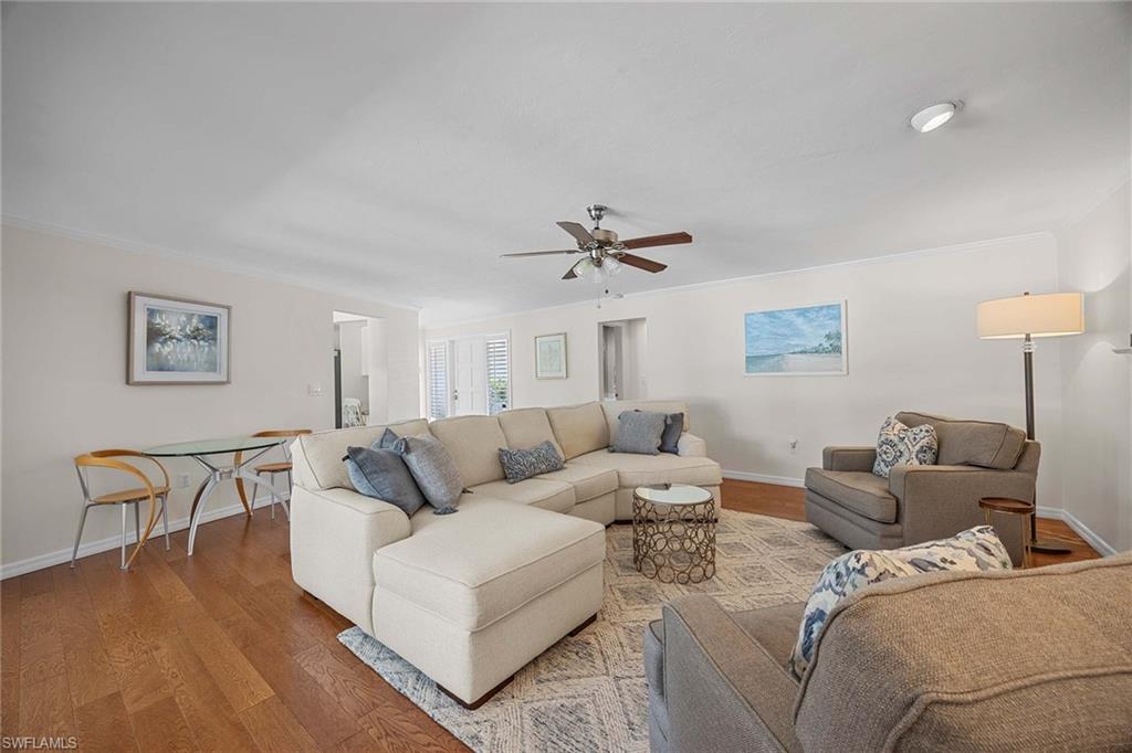 707 Portside Drive Naples, FL 34103 - Photo 7 of 35 a living room with furniture and a wooden floor