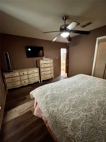 a spacious bathroom with a granite countertop sink a toilet and a mirror