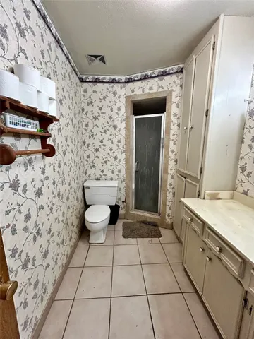 a bedroom with a bed and flat screen tv