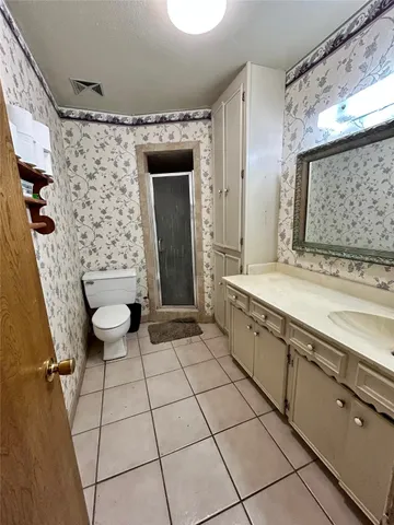 a spacious bathroom with a sink a mirror and a bathtub