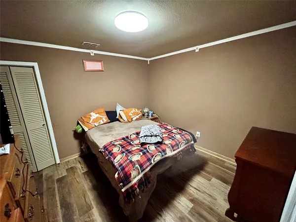 a bedroom with a bed and flat screen tv