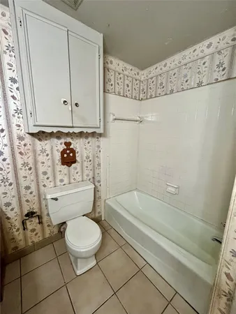 a bedroom with a bed closet and flat tv screen