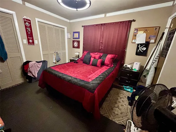 a living room with a flat screen tv and gym equipment