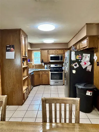 a kitchen with stainless steel appliances granite countertop a refrigerator and a stove top oven