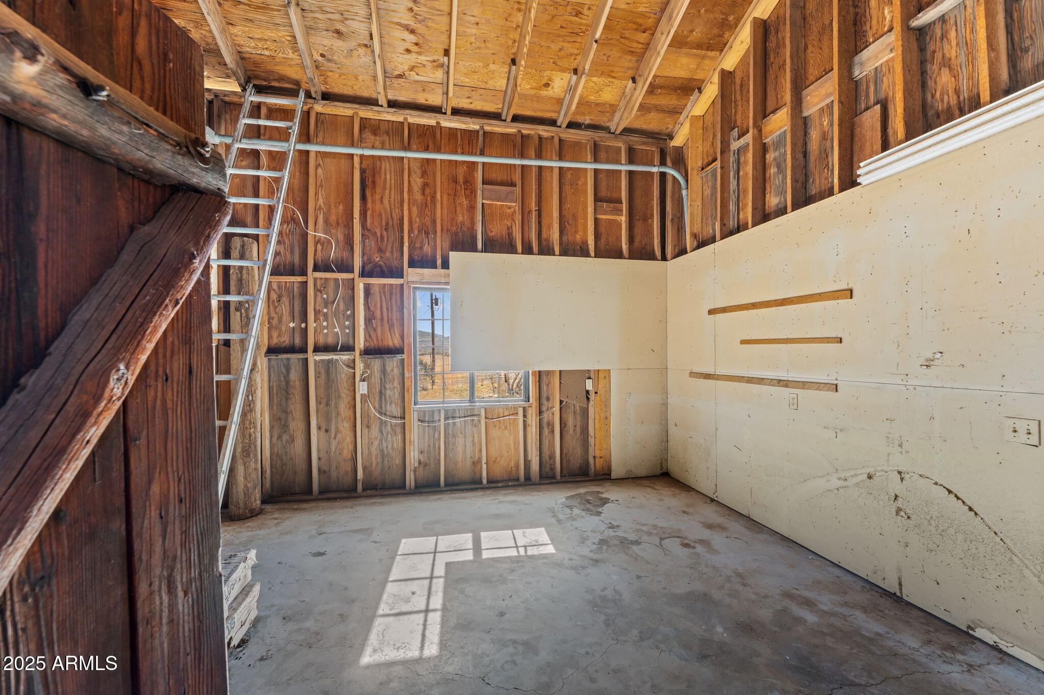 16057 Sickles Ranch Road Peeples Valley, AZ 86332 - Photo 24 of 39 a view of a garage with wooden wall