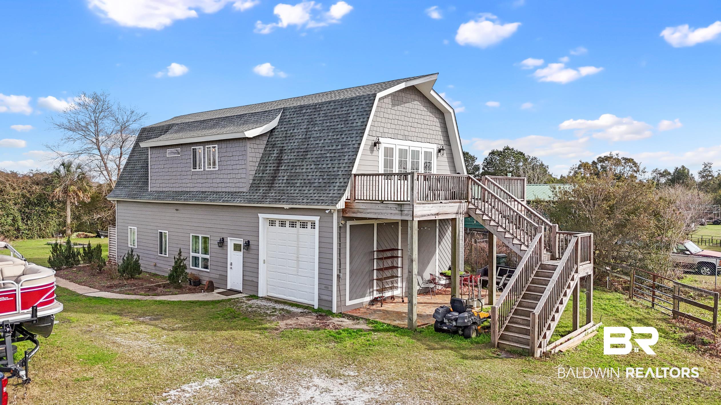 13358 County Road 91 Elberta, AL 36530 - Photo 3 of 47 View of home's exterior featuring a garage, a wooden deck, and a yard