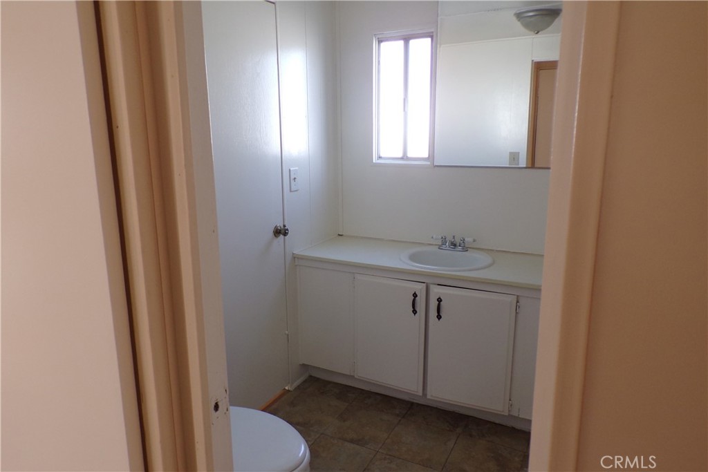 12710 3rd Street, Unit 32 Yucaipa, CA 92399 - Photo 12 of 14 a bathroom with a sink toilet and vanity