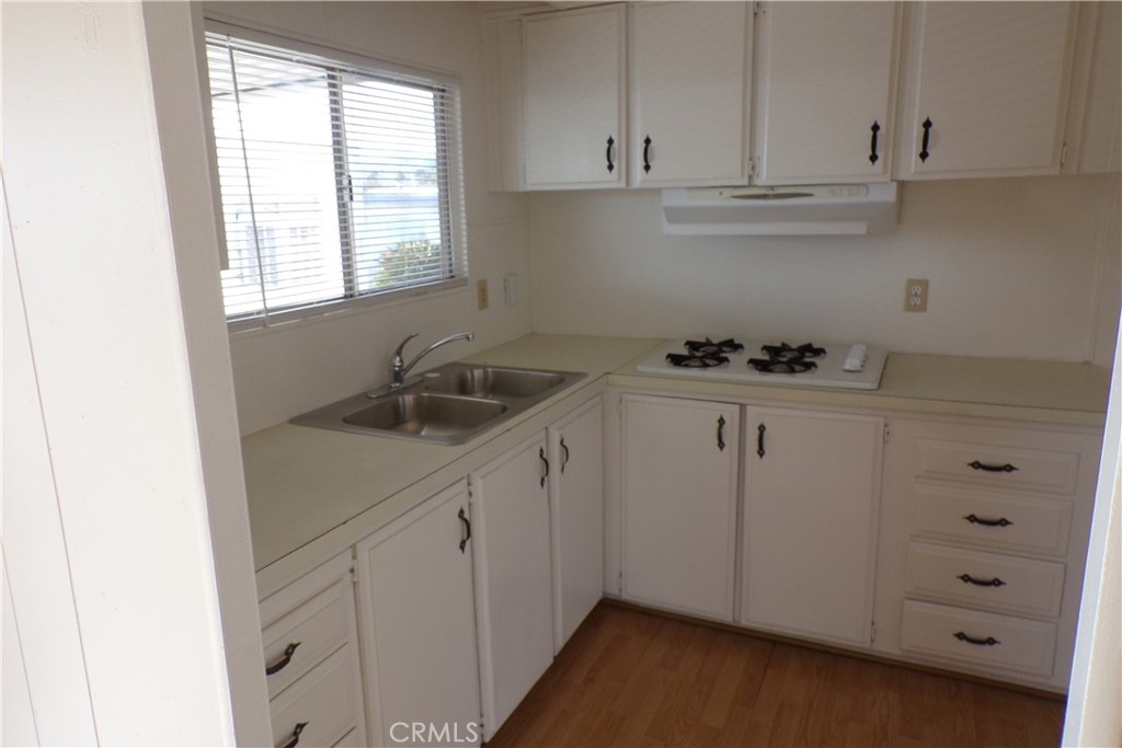 12710 3rd Street, Unit 32 Yucaipa, CA 92399 - Photo 8 of 14 a kitchen with cabinets appliances a sink and a window
