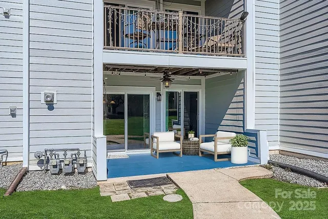 a view of a house with a yard and sitting area