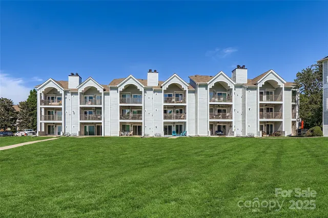a front view of building with yard and green space