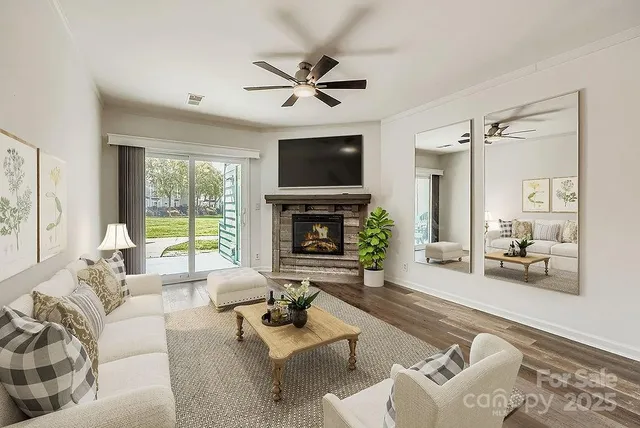 a living room with furniture a fireplace and a flat screen tv