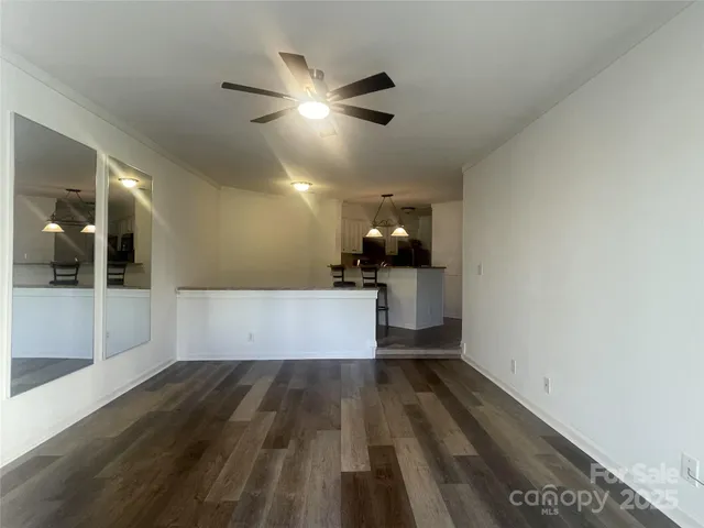 a view of a room with wooden floor and staircase