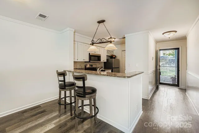 a view of a livingroom with furniture and wooden floor