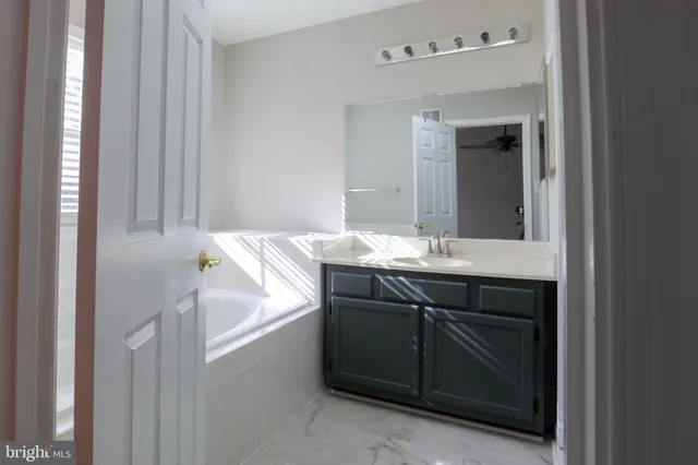 a bathroom with a bathtub and a sink