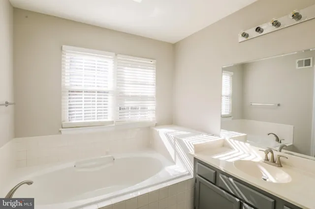 wooden floor in an empty room with a chandelier fan
