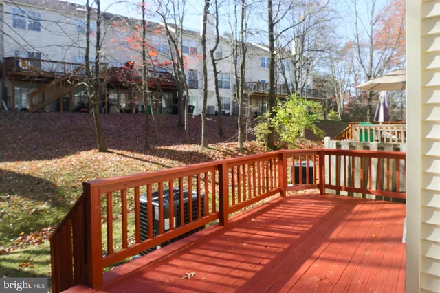 a view of a brick house with a wooden deck