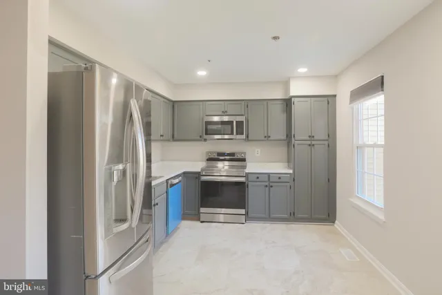 a kitchen with a refrigerator sink and microwave