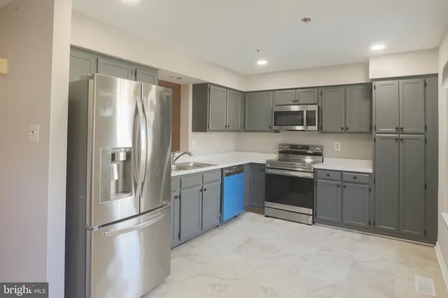 a kitchen with a refrigerator and a sink