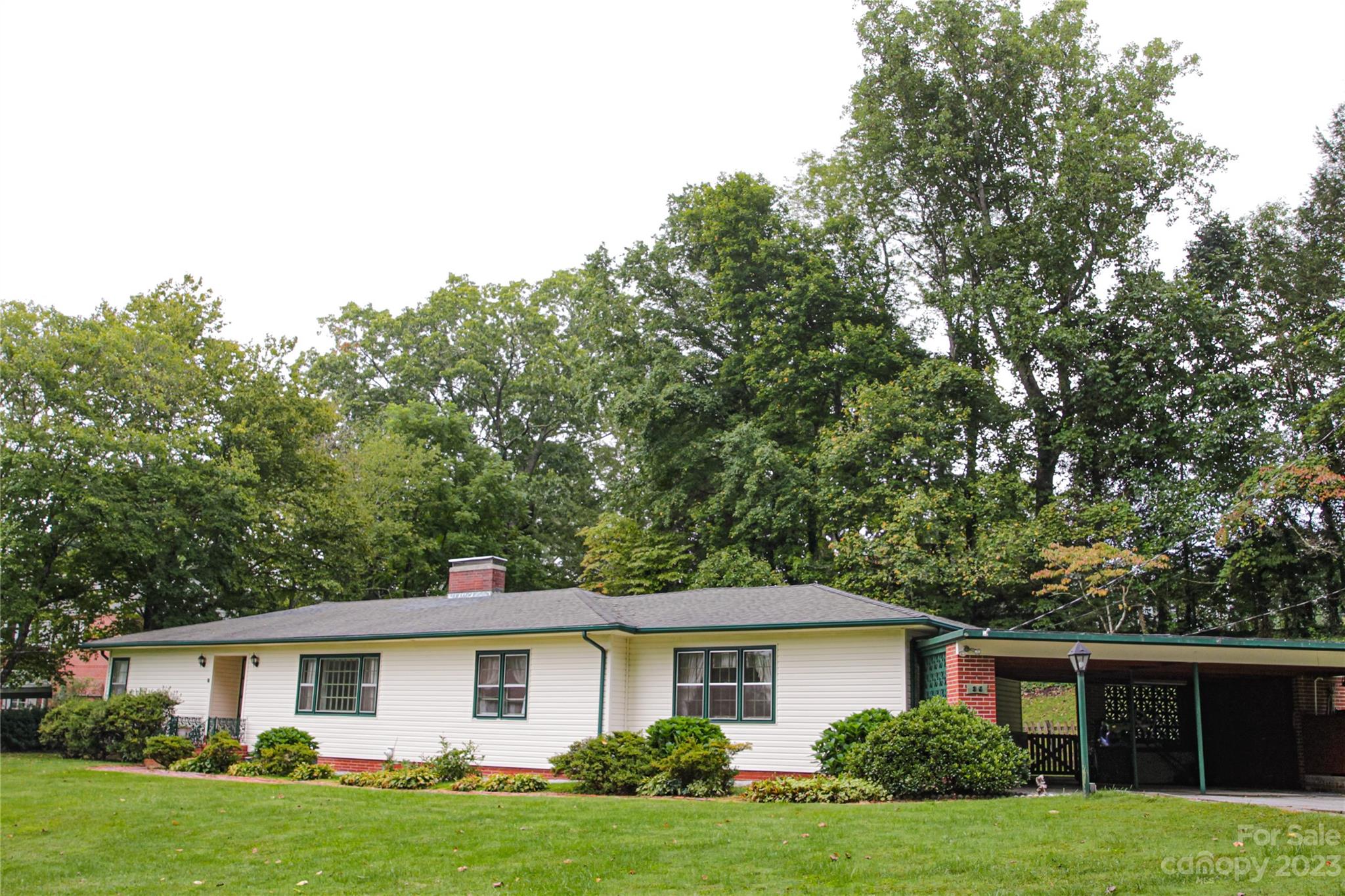 a front view of house with yard and green space