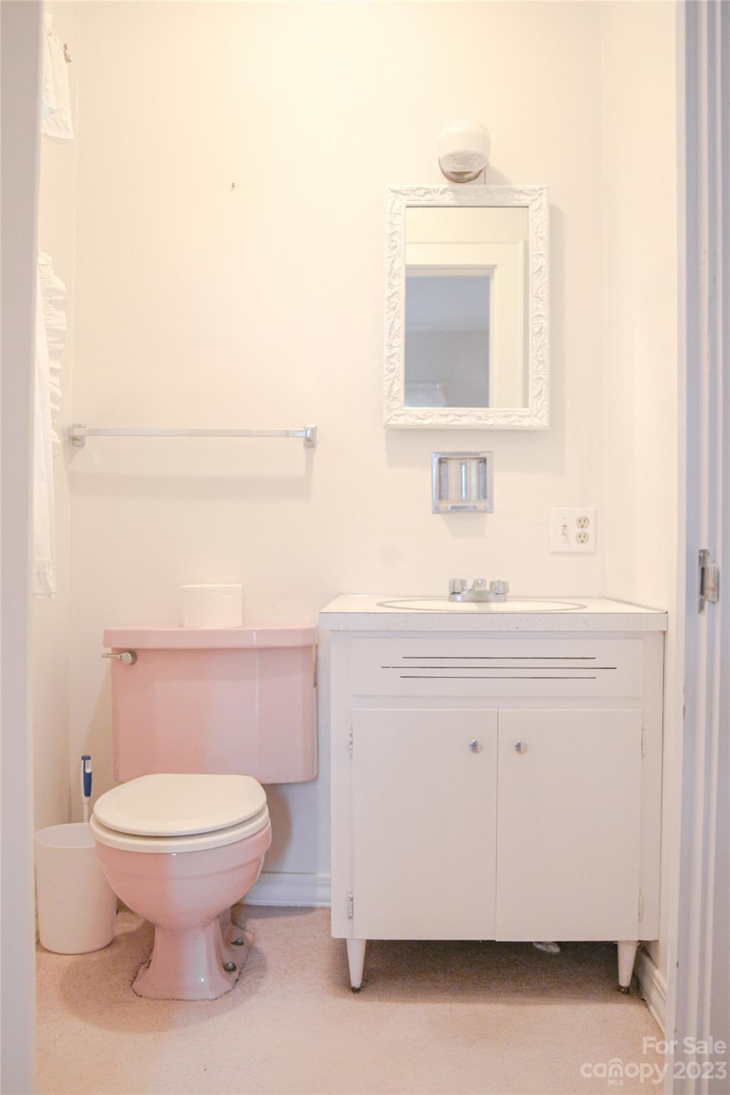 35 Rhododendron Avenue Spruce Pine, NC 28777 - Photo 15 of 37 a bathroom with a toilet a sink and mirror