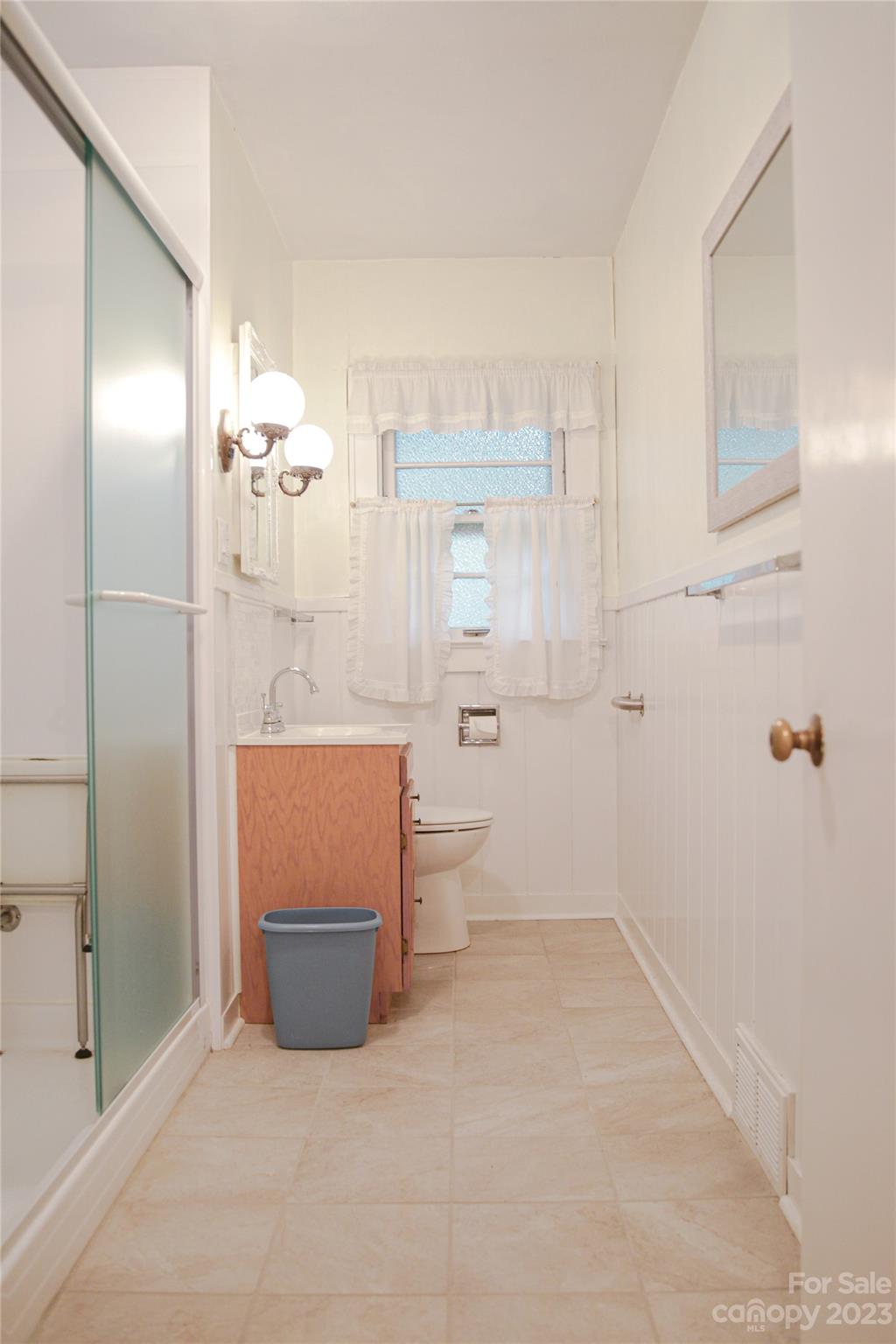 35 Rhododendron Avenue Spruce Pine, NC 28777 - Photo 17 of 37 a bathroom with a granite countertop sink a toilet and shower