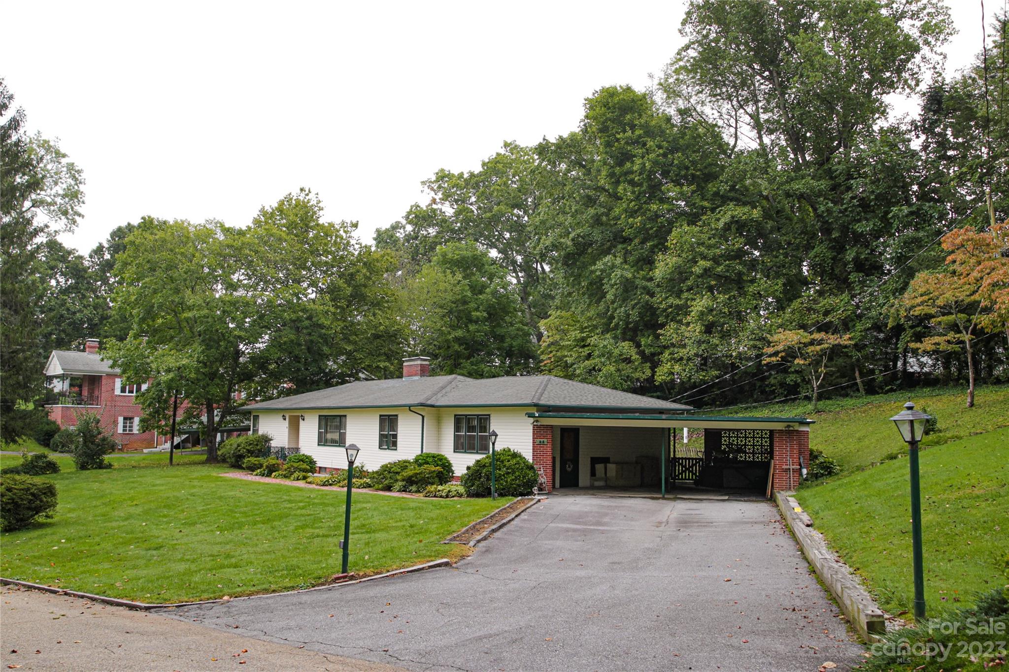 35 Rhododendron Avenue Spruce Pine, NC 28777 - Photo 2 of 37 a front view of a house with a garden