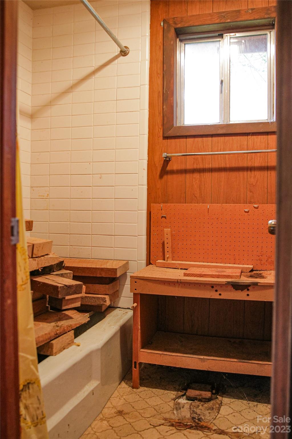 35 Rhododendron Avenue Spruce Pine, NC 28777 - Photo 33 of 37 a bathroom with a bathtub and a window