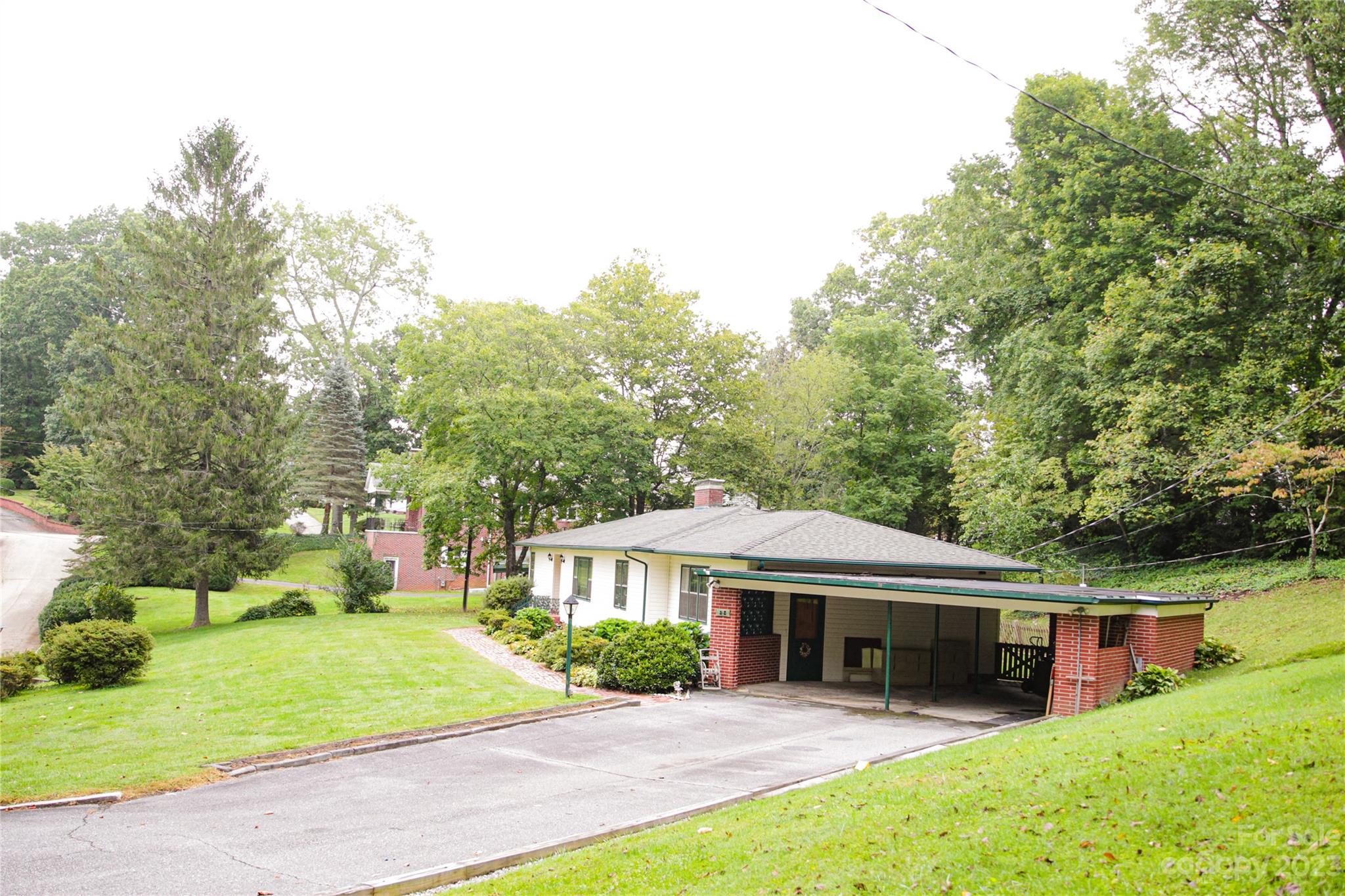 35 Rhododendron Avenue Spruce Pine, NC 28777 - Photo 35 of 37 a view of a house with a yard and large tree