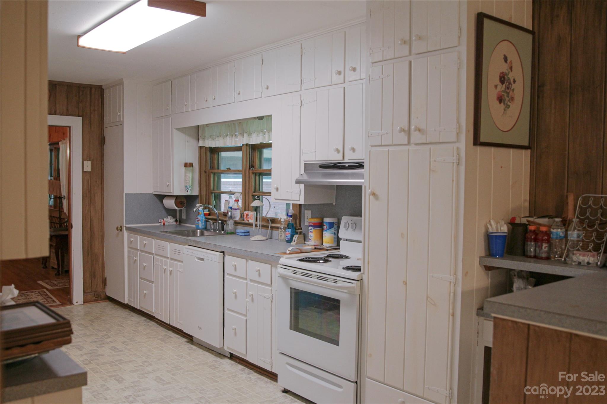 35 Rhododendron Avenue Spruce Pine, NC 28777 - Photo 5 of 37 a kitchen with cabinets appliances and a sink