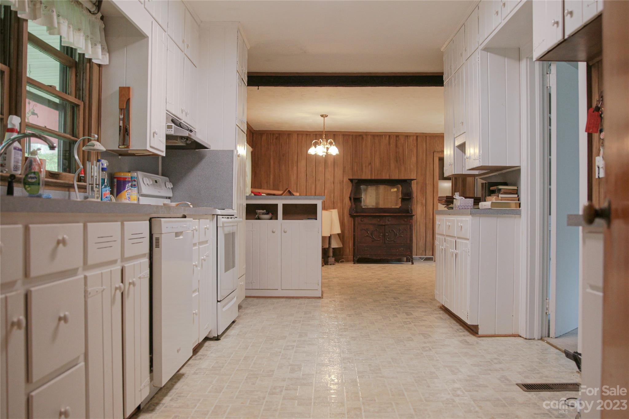 35 Rhododendron Avenue Spruce Pine, NC 28777 - Photo 6 of 37 a view of a kitchen with refrigerator and wooden floor
