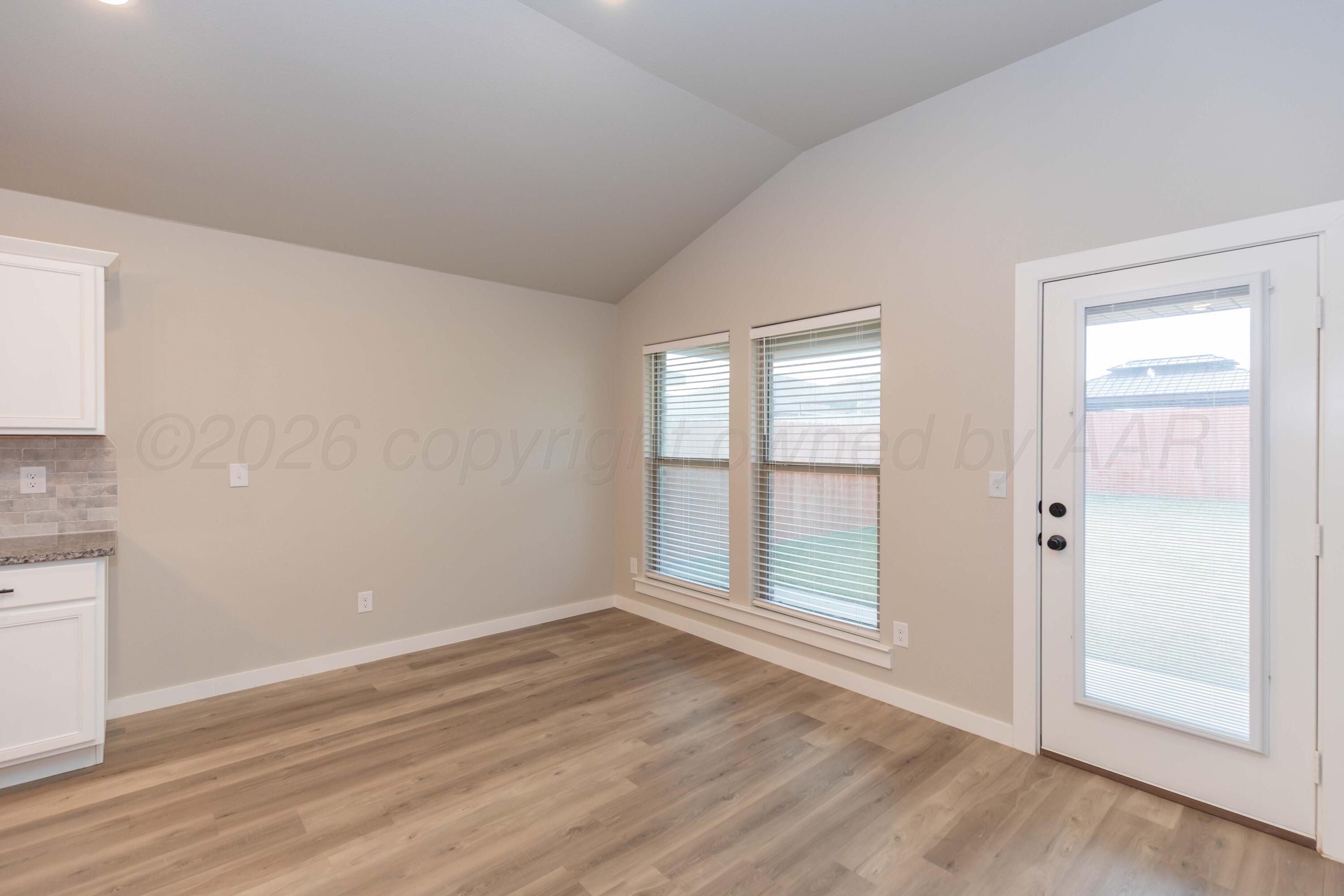 1807 Moon River Road Amarillo, TX 79118 - Photo 13 of 37 an empty room with wooden floor and windows
