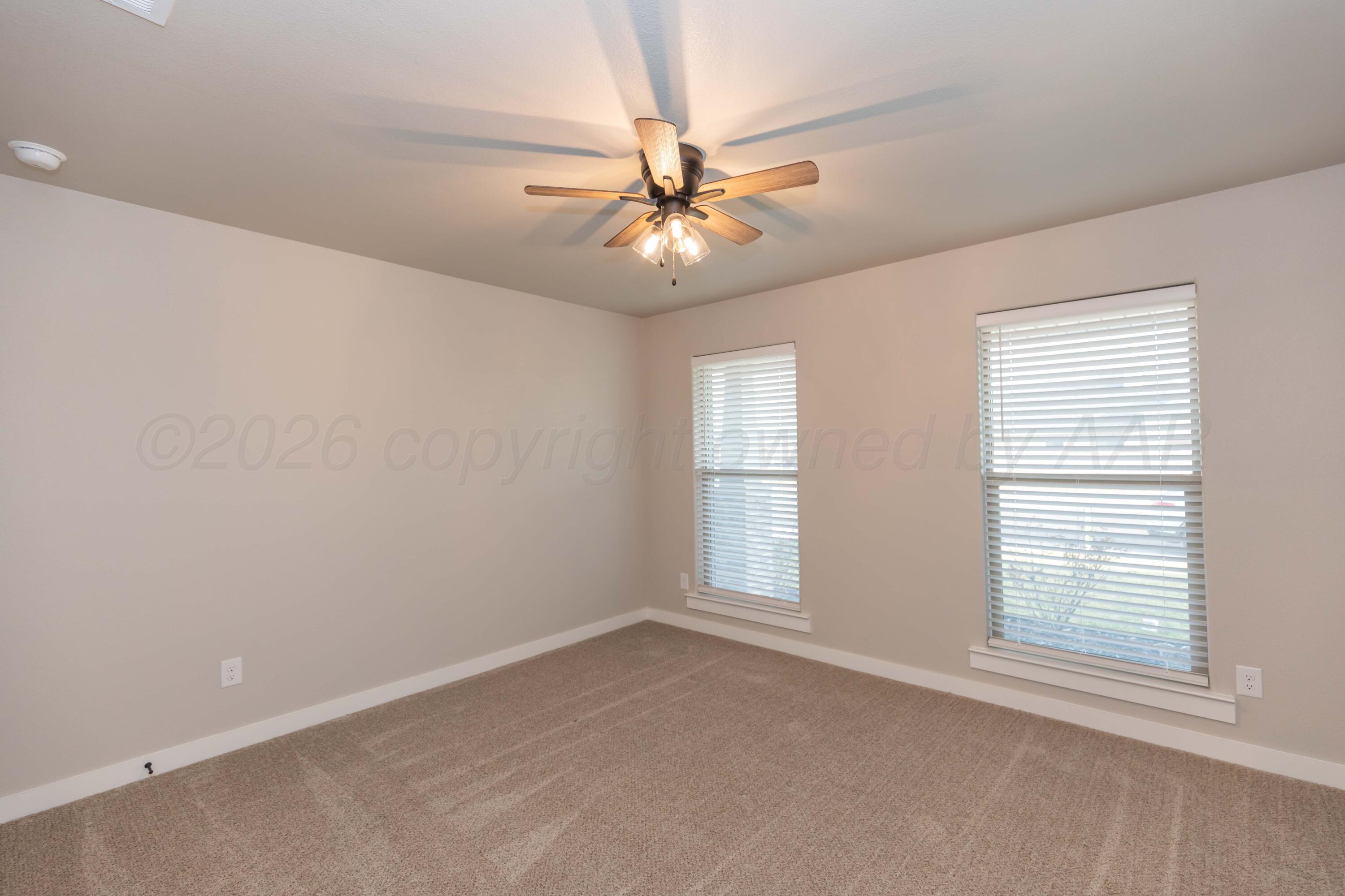 1807 Moon River Road Amarillo, TX 79118 - Photo 16 of 37 an empty room with windows and fan
