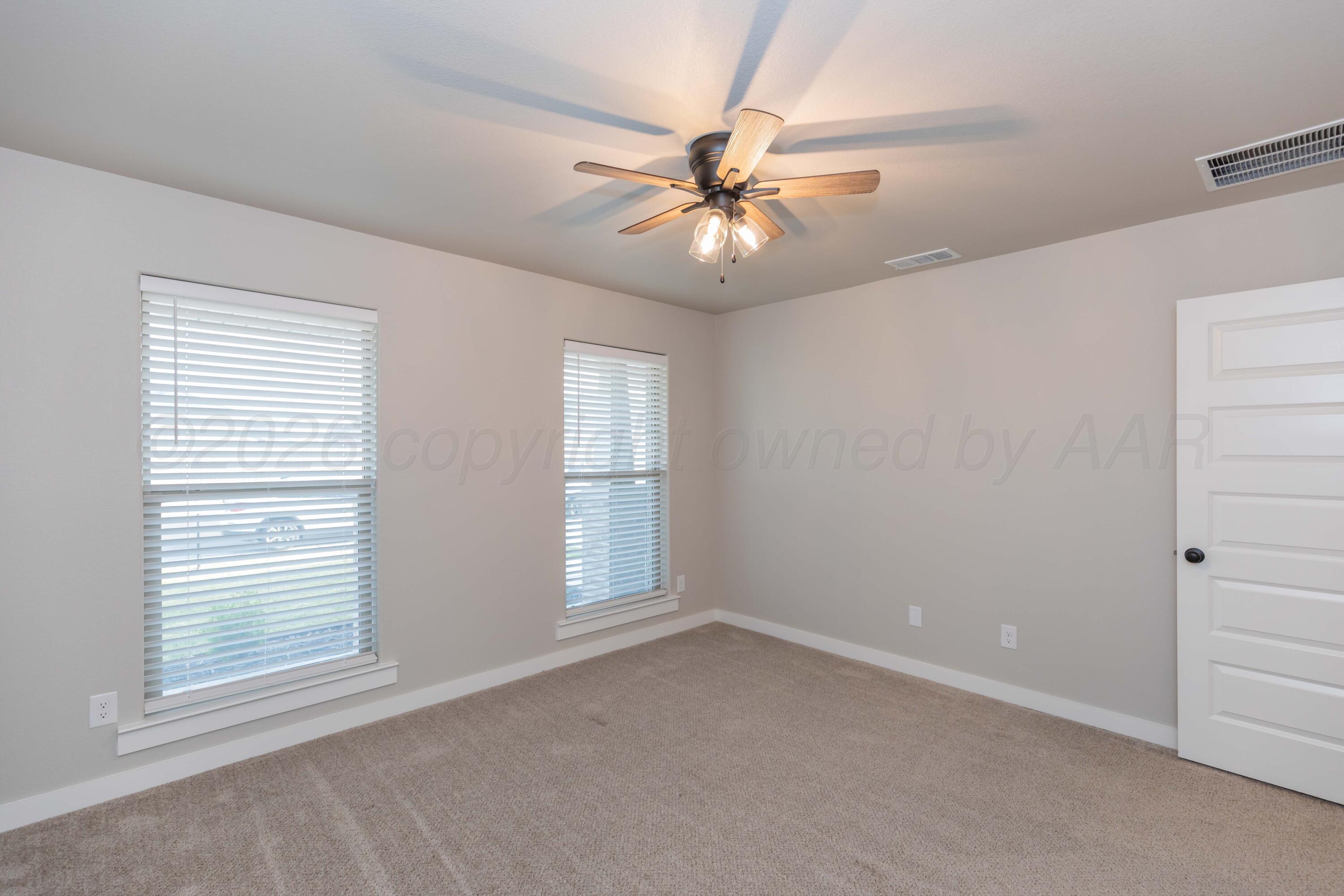 1807 Moon River Road Amarillo, TX 79118 - Photo 19 of 37 an empty room with windows and fan