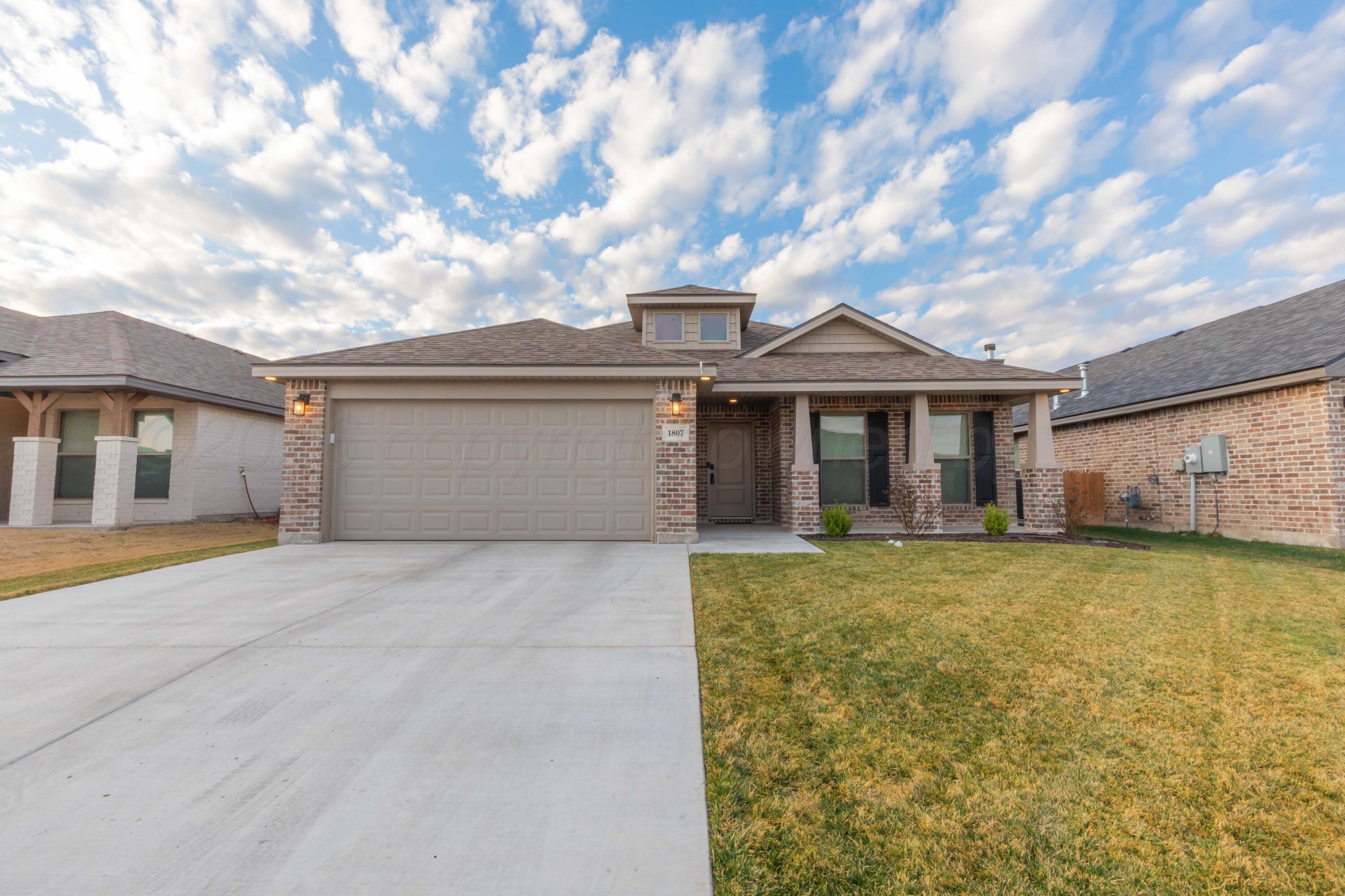 1807 Moon River Road Amarillo, TX 79118 - Photo 2 of 37 a front view of a house with a garden