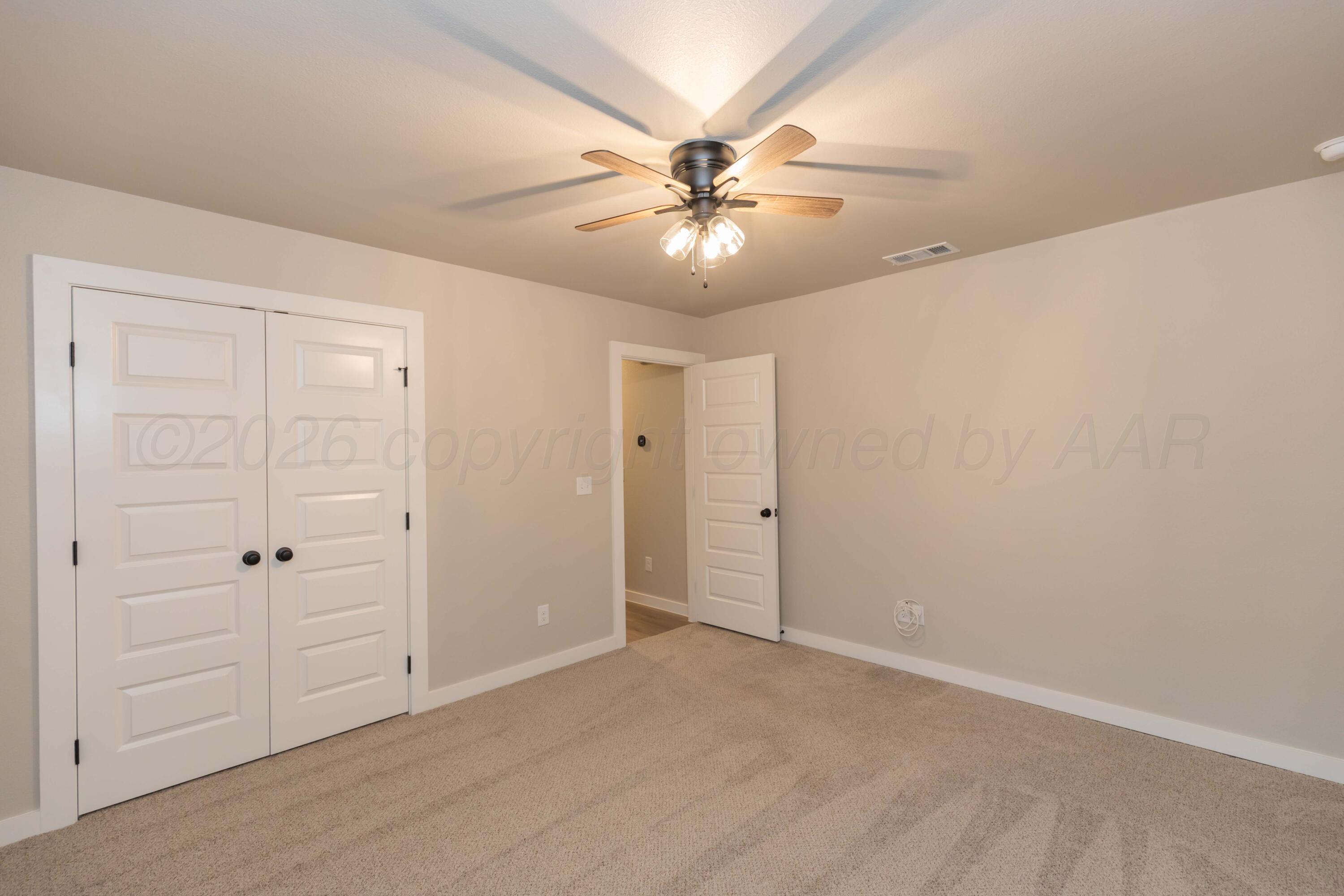 1807 Moon River Road Amarillo, TX 79118 - Photo 25 of 37 an empty room with closet and a ceiling fan