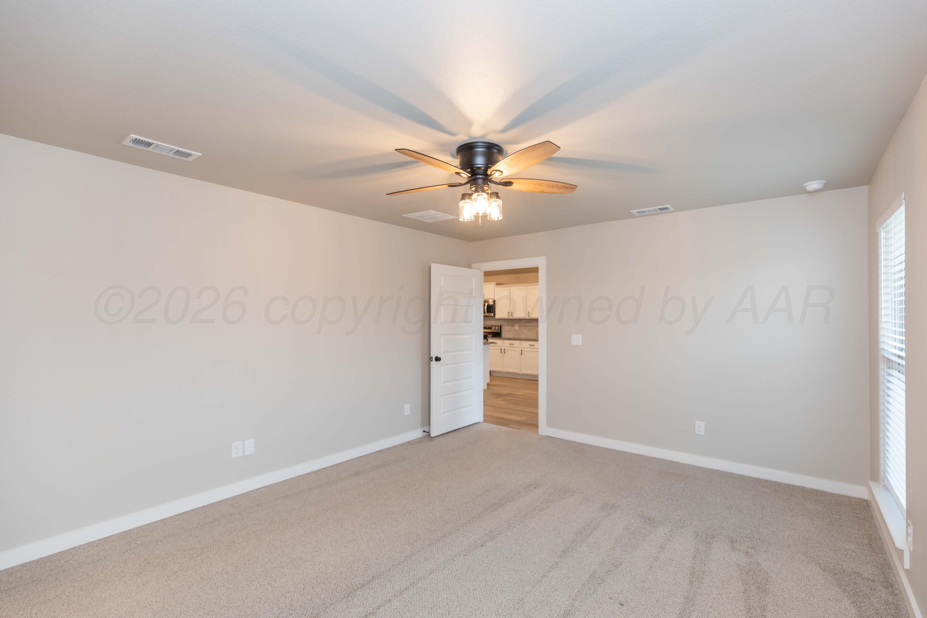 1807 Moon River Road Amarillo, TX 79118 - Photo 29 of 37 an empty room with closet and a ceiling fan