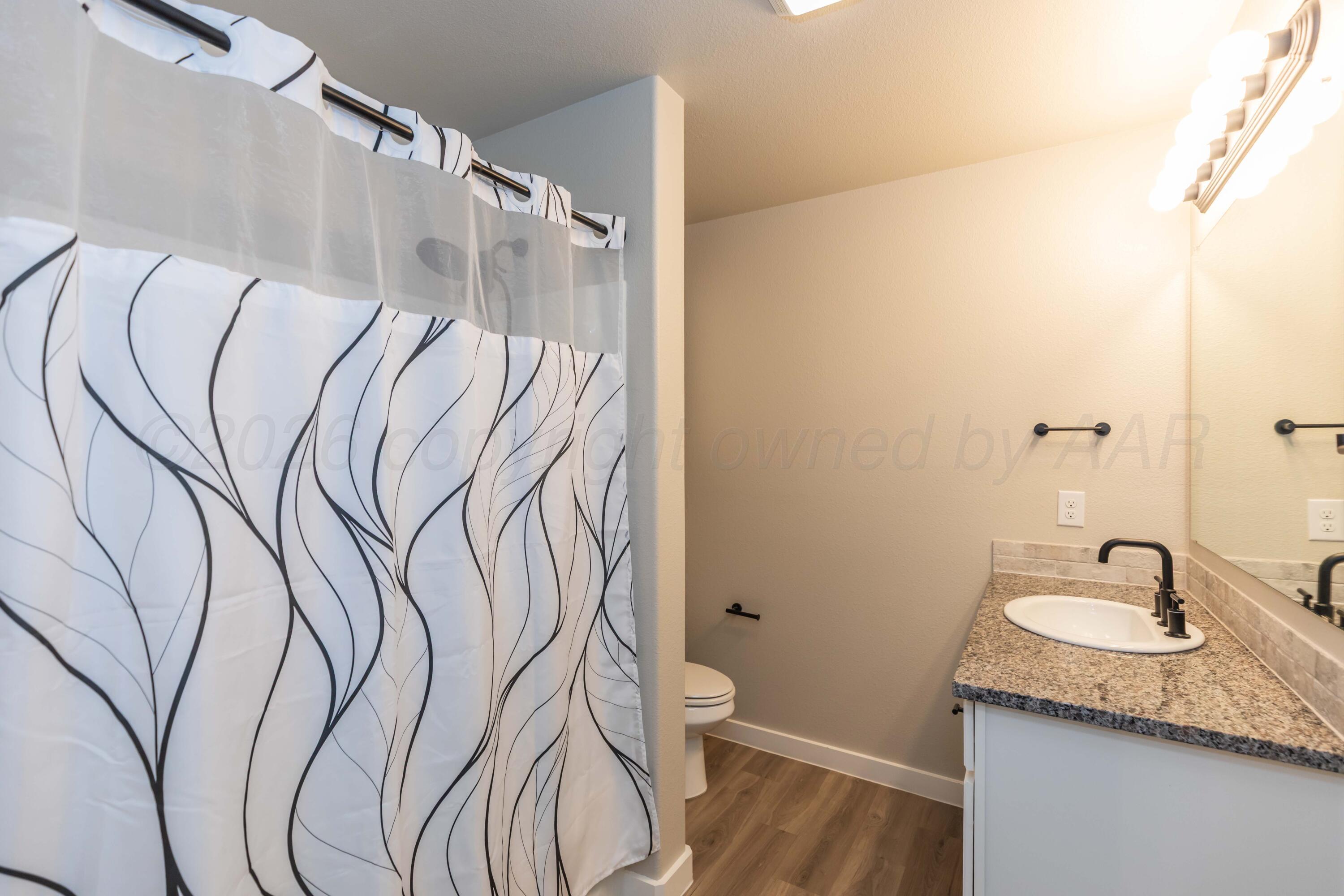 1807 Moon River Road Amarillo, TX 79118 - Photo 31 of 37 a bathroom with a granite countertop sink and a mirror