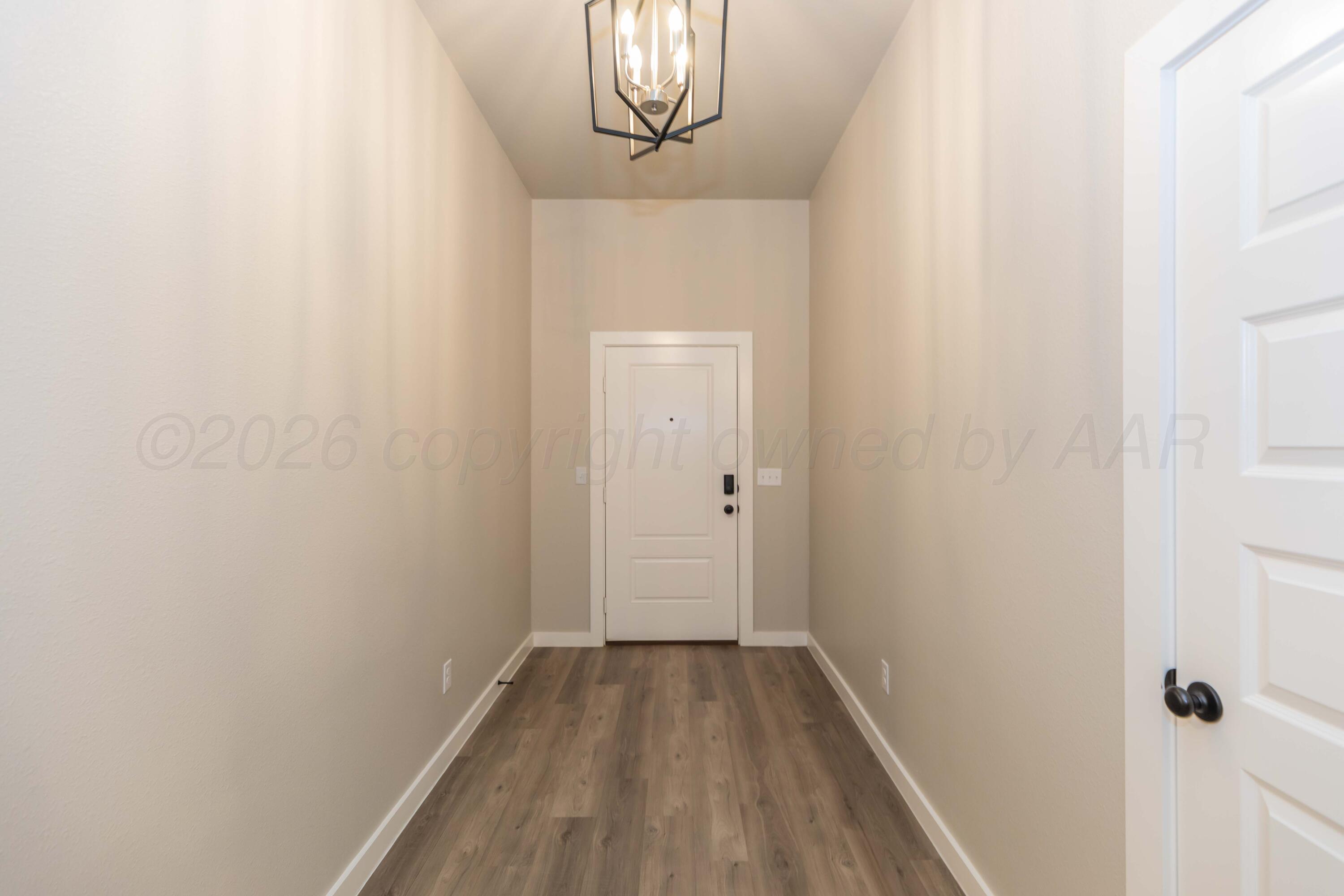1807 Moon River Road Amarillo, TX 79118 - Photo 5 of 37 a view of a hallway with wooden floor
